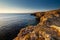 Amazing sunrise over the rising cliffs and rocks in Malta, with spectacular colors in the sky and reflections of the sun in het Me