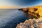 Amazing sunrise over the rising cliffs and rocks in Malta, with spectacular colors in the sky and reflections of the sun in het Me