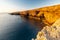 Amazing sunrise over the rising cliffs and rocks in Malta, with spectacular colors in the sky and reflections of the sun in het Me