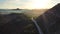 Amazing sunset aerial top drone view of high-speed road between the picturesque mountains. Top down view of picturesque mountain