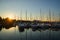 Amazing sunset, boats in the harbor, yachts in a bay of lake at sunset light.