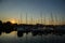 Amazing sunset, boats in the harbor, yachts in a bay of lake at sunset light.