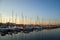 Amazing sunset, boats in the harbor, yachts in a bay of lake at sunset light.