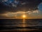 Amazing sunset on an empty beach - birds flying near horizon