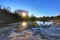 Amazing sunset landscape at Bushy Creek in Round Rock, Texas. Sun and Stones are reflected in water with blue sky.