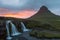Amazing sunset over Kirkjufell volcano with pink.