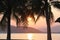 Amazing sunset over the sea surrounded by palm trees