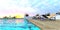 Amazing sunset. The red setting sun sets over the horizon. View from the pool in the recreation area of an elite club hotel. 3d