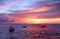 During an amazing sunset, a view from the Nightcliff jetty, Darwin, NT Australia, of two small boats sailing on the sea.