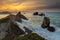 Amazing sunset view over a wavy seascape in the Urros de Liencres, Cantabria, Spain