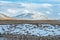 Amazing Tibetan landscape with snowy mountains and cloudy sky