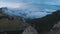 Amazing time lapse cloudscape with mysterious fog flying over mountain highland forests and wild peaks -