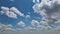 Amazing time lapse of soft white clouds moving through beautiful thick fluffy clouds slowly on the clear blue sky