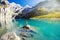 Amazing tourquise Oeschinnensee with waterfalls, wooden chalet and Swiss Alps, Berner Oberland, Switzerland