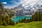 Amazing tourquise Oeschinnensee with waterfalls, wooden chalet and Swiss Alps in Berner Oberland, Switzerland.