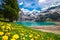 Amazing tourquise Oeschinnensee with waterfalls, wooden chalet and Swiss Alps, Berner Oberland, Switzerland