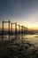 Amazing tropical sunset background, wooden structure on the muddy beach