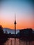 Amazing vertical shot of the Berliner Fernsehturm on orange sunset background