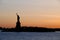 Amazing view of american icon the Statue of Liberty, at sunset. Space for text