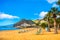 Amazing view of beach las Teresitas with yellow sand, umbrellas, longues and palm trees. Location: Santa Cruz de