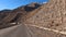 Amazing view of the beautiful hilly landscape. Serpentine roads. An exciting road adventure in the mountains of Kyrgyzstan.