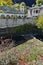 Amazing view of Church of the Assumption, river and Autumn tree in town of Shiroka Laka, Bulgaria