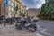 Amazing view of the city parking for scooters on Paseo Del Parque in Malaga. Close up photo on lots of parked assorted scooters.