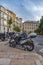 Amazing view of the city parking for scooters on Paseo Del Parque in Malaga. Close up photo on lots of parked assorted scooters.