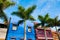 Amazing view on colourful houses and palm trees on street. Location: Puerto de la Cruz town, Tenerife, Canary Islands. Artistic p