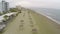 Amazing view on deserted beach with straw parasols and chaise-longues, tourism