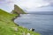 Amazing view of Drangarnir gate with sheeps in front of Tindholmur in Vagar island, Faroe Islands, Denmark north Atlantic