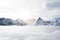 Amazing view of great snow covered winter mountains above the clouds