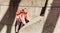 Amazing view of happy, joyful smiled little girl hiking on concrete wall