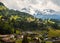 Amazing view of the hillside village and snowy slopes of the Swiss Alps. Colorful summer view of village. Idyllic