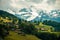 Amazing view of the hillside village and snowy slopes of the Swiss Alps. Colorful summer view of village. Idyllic