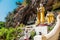 Amazing view of lot Buddhas statues and religious carving on limestone rock in sacred Kaw Goon cave. Hpa-An, Myanmar. Burma.