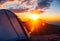 Amazing view of the mountain sunset from camping on a tent opening. Generative AI