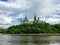 An amazing view of parliament hill surrounded by green forest and chateau laurier from the perspective of a tour boat