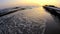 Amazing view of sea waves on the beach at sunset.