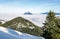 Amazing View from Snow Mountain to snowy Mountain Range above inversion foggy cloud layer. Above the clouds on