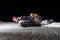 An amazing view of a snowcat in the snow at the top of a ski piste at night in the alps St Moritz Switzerland in winter