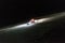 An amazing view of a snowcat in the snow at the top of a ski piste at night in the alps St Moritz Switzerland in winter