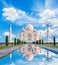 Amazing view on the Taj Mahal in sun light with reflection in wa