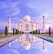 Amazing view on the Taj Mahal in sun light with reflection in wa