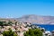 Amazing view on tiny colorful houses on rocks and oleander trees near the Mediterranian sea on Greek island in sunny summer day