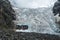 Amazing view to full Adishi glacier icefall and its small waterfall in mountains of Svaneti Georgia