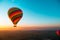 Amazing view of a vibrant colorful balloon at sunrise, flame firing to propel the balloon upwards. Balloon ride at luxor, egypt,