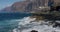 Amazing view. Waves breaking on the rocks. Splashing waves. Canary Islands. Tenerife. Los Gigantes. Close up.