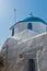 Amazing view of White chuch with blue roof in town of Parakia, Paros island, Greece