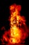amazing violent explosion of fire in the dark night. The combustion creates big flames, gas en generates a wide light. Vertical